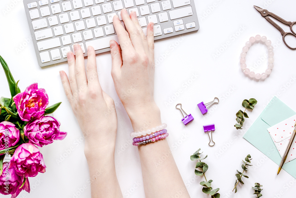 Woman office desk with flowers on white background top view