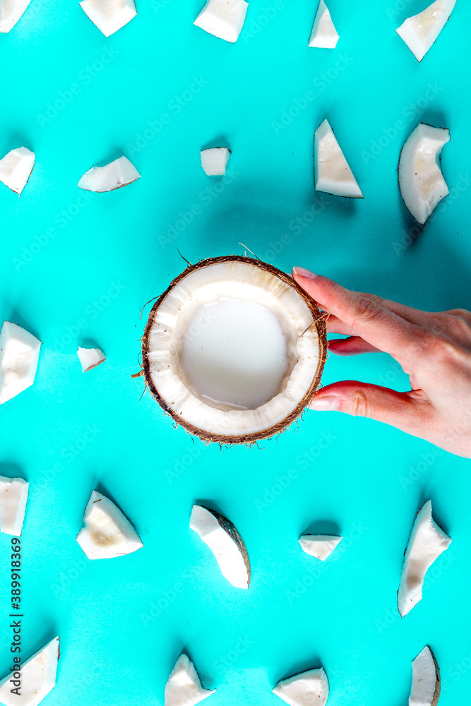 concept organic cosmetics with coconut on blue background top view