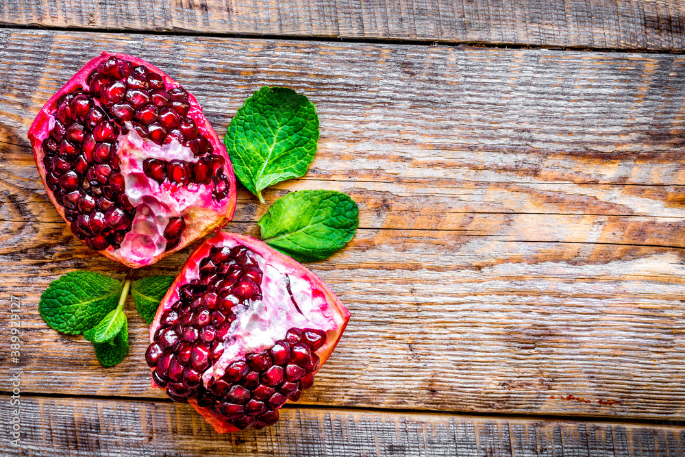 sliced pomegranate on wooden background top view