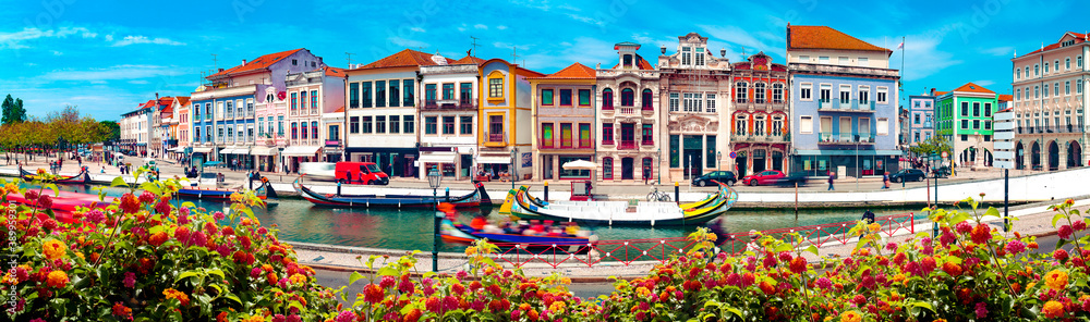 Traditional boats on the canal in Aveiro, Portugal. 
Aveiro River on a sunny afternoon on a summer d