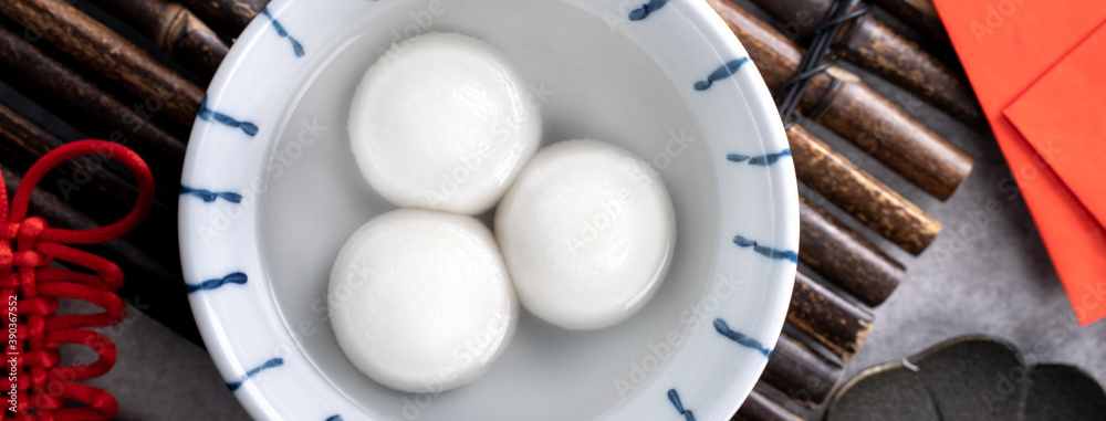 Top view of big tangyuan yuanxiao in a bowl on gray background for lunar new year food.