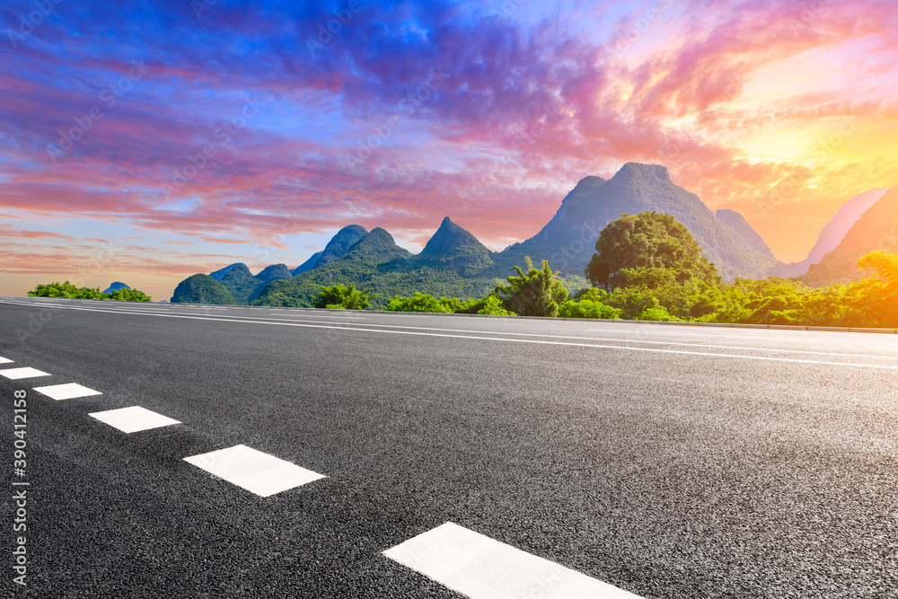 Empty asphalt highway and green mountain natural scenery in Guilin at sunrise,China.