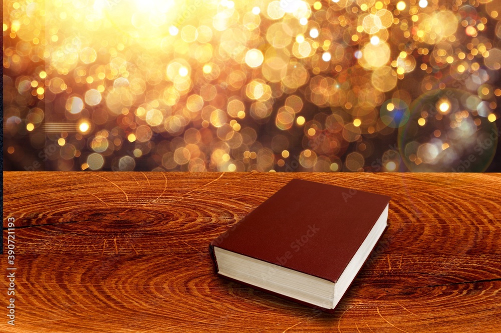 Open book on old wooden table.