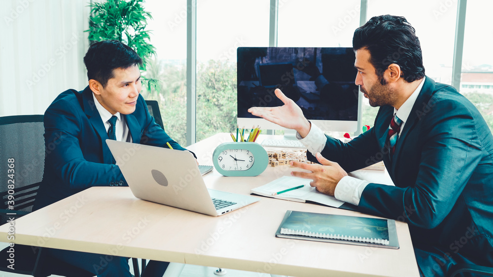 Two business people talk project strategy at office meeting room. Businessman discuss project planni