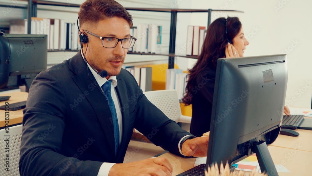 Business people wearing headset working in office to support remote customer or colleague. Call cent