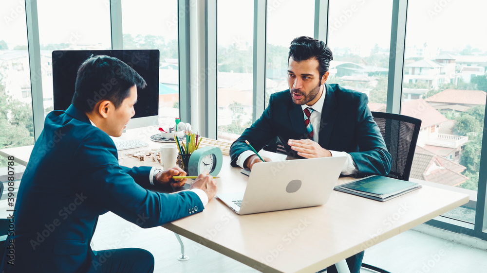 Two business people talk project strategy at office meeting room. Businessman discuss project planni