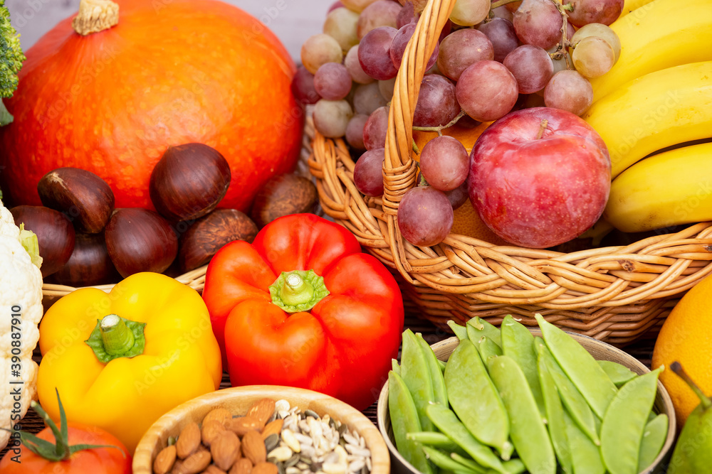 Group vegetables and Fruits Apples, grapes, oranges, and bananas in the wooden basket with carrots, 