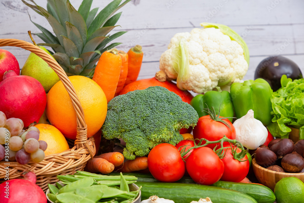 Group vegetables and Fruits Apples, grapes, oranges, and bananas in the wooden basket with carrots, 