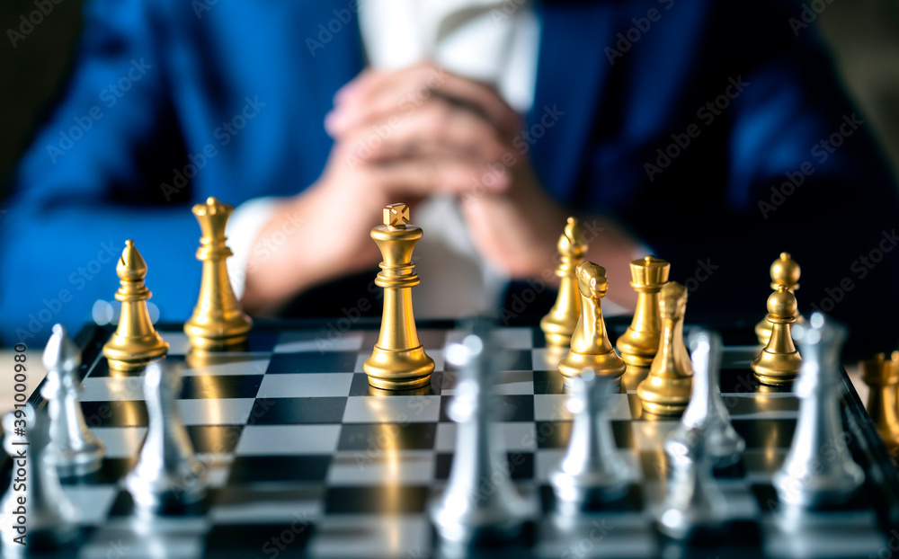 close up business man formal suit hand think and planing to win chess board game business stratey or