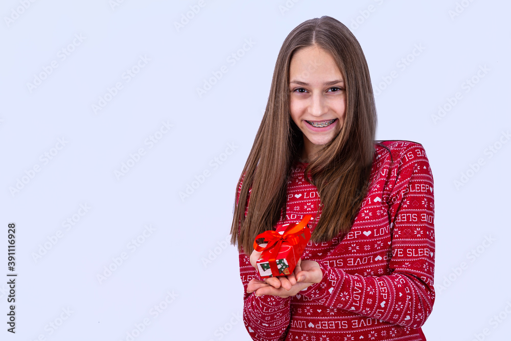 Young caucasian girl with dental braces is smiling. Emotional girl holding gifts and showing happine