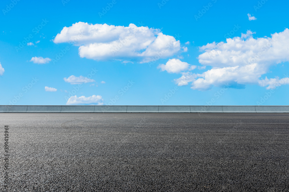 New asphalt road and blue sky with white clouds.