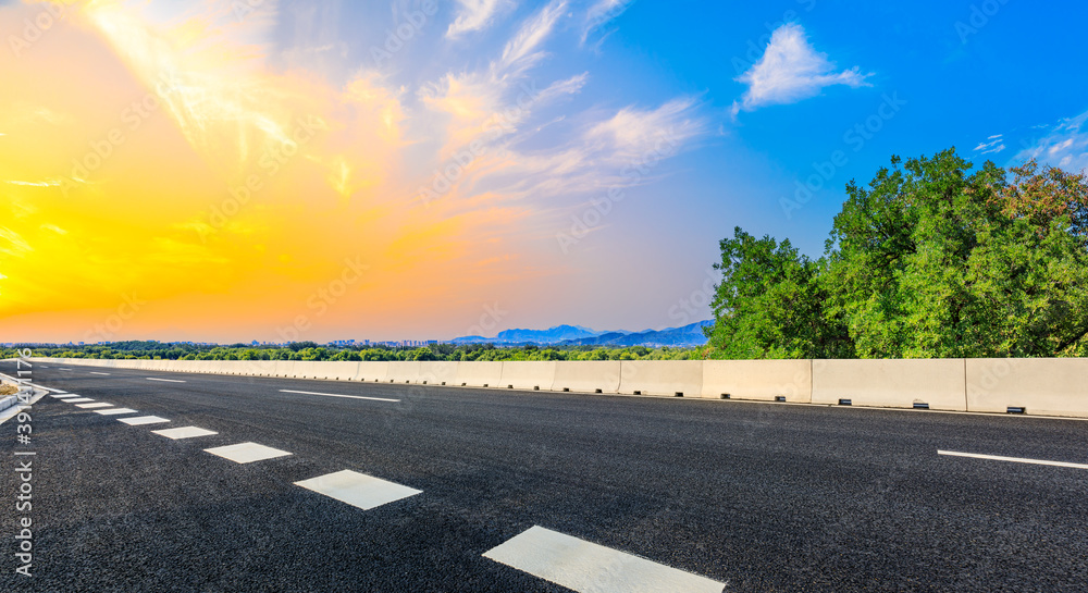 New asphalt road and green tree with mountain landscape in the suburbs of the city.