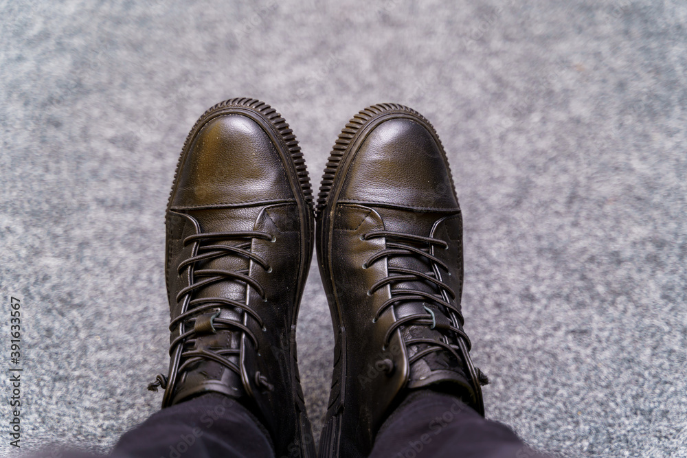 Brown boots. Leather shoes and black jeans. Man`s fashion. Selective focus.