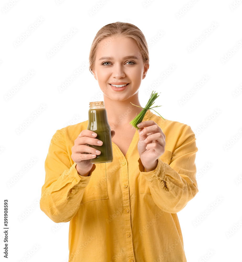 Young woman with wheatgrass and juice on white background