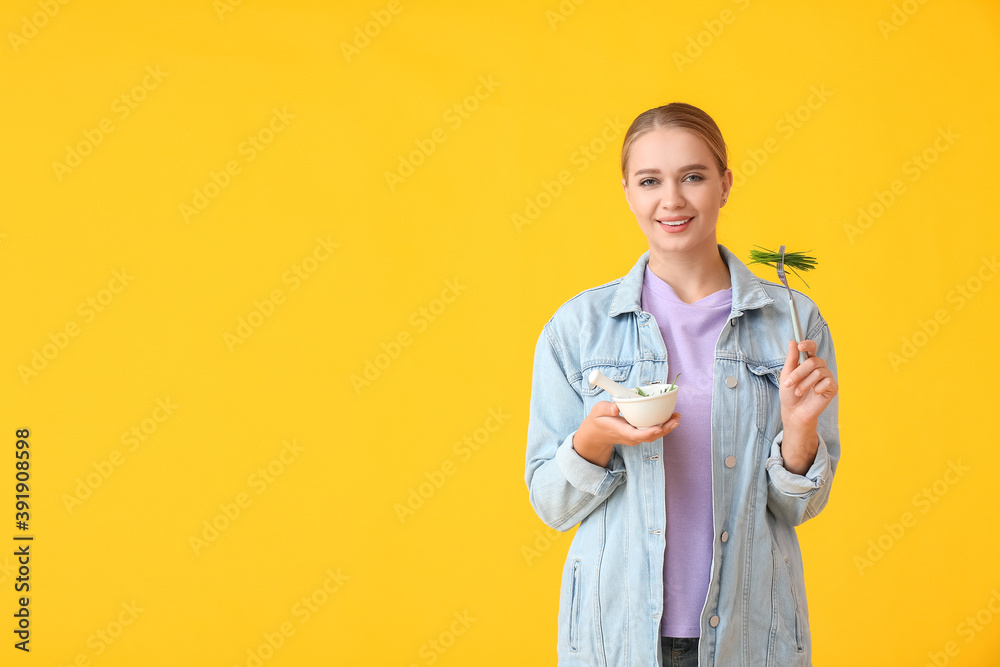 年轻女子在彩色背景下吃冰草