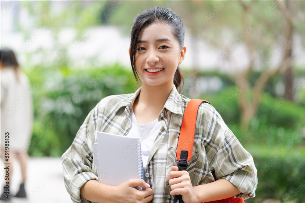 女学生高兴地把她的书带到了学校