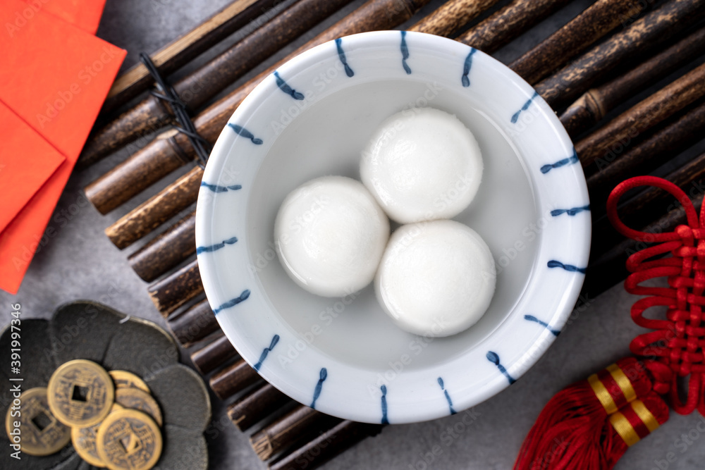 Top view of big tangyuan yuanxiao in a bowl on gray background for lunar new year food.