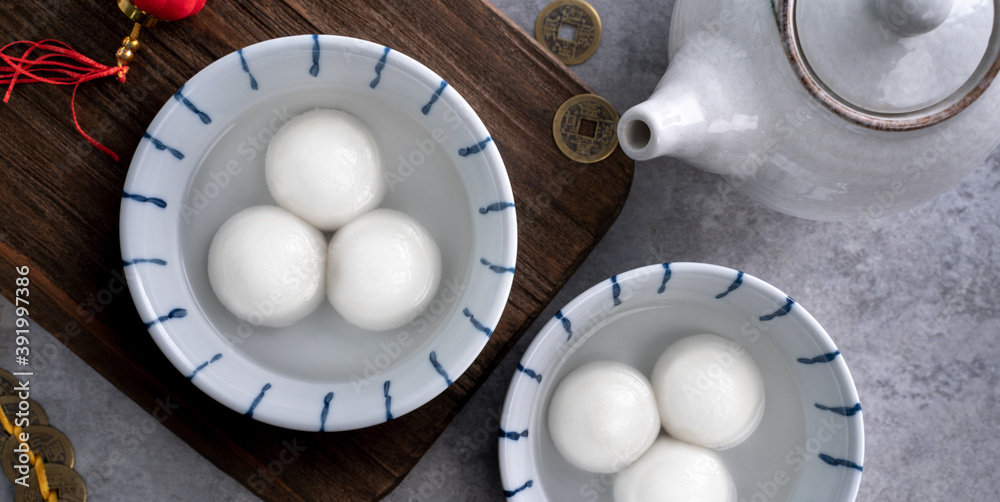 Top view of big tangyuan yuanxiao in a bowl on gray background for lunar new year food.