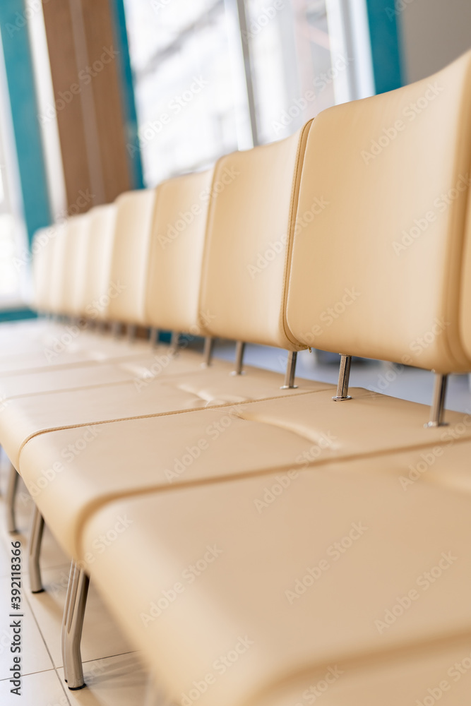 Lobby or waiting hall in an airport. Raw with leather light chairs. Selective focus.