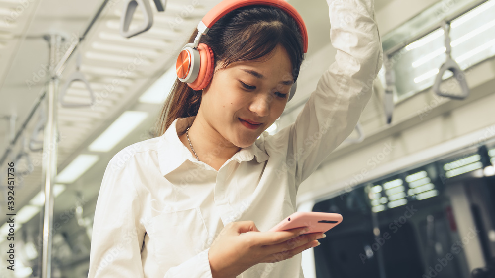 Young woman mobile phone on public train . Urban city lifestyle commuting concept .