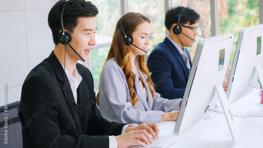 Business people wearing headset working in office to support remote customer or colleague. Call cent