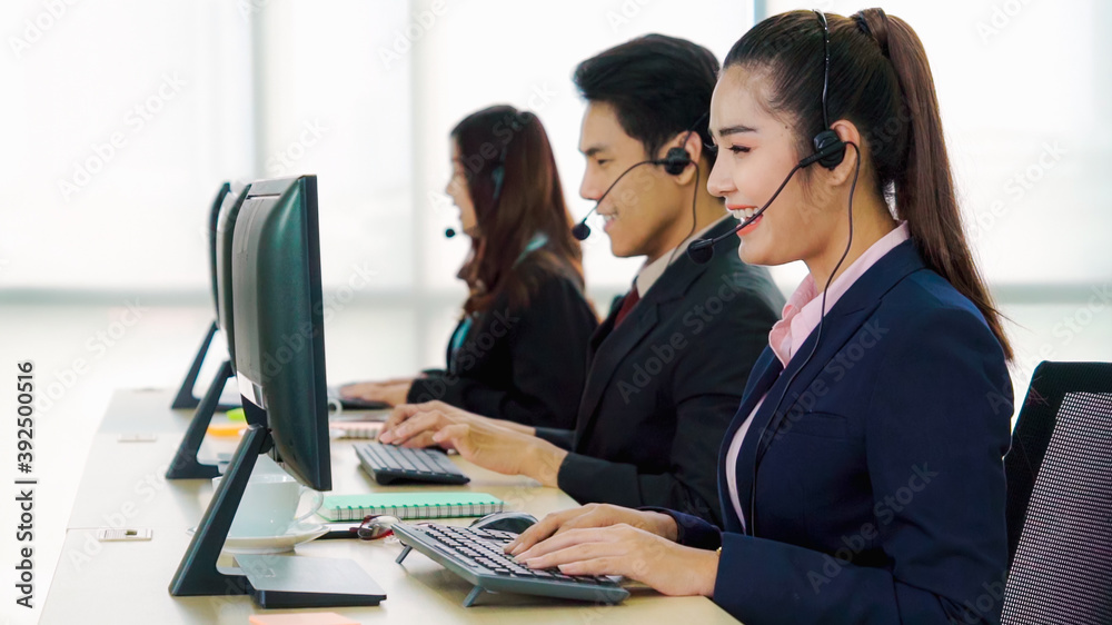 Business people wearing headset working in office to support remote customer or colleague. Call cent