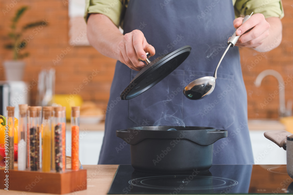 Man cooking dinner in kitchen