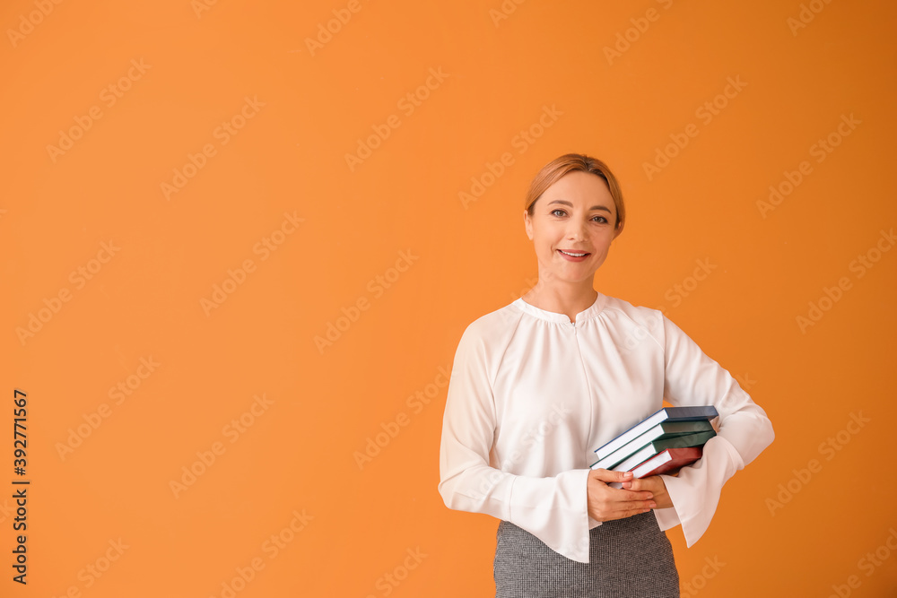 Portrait of female teacher on color background