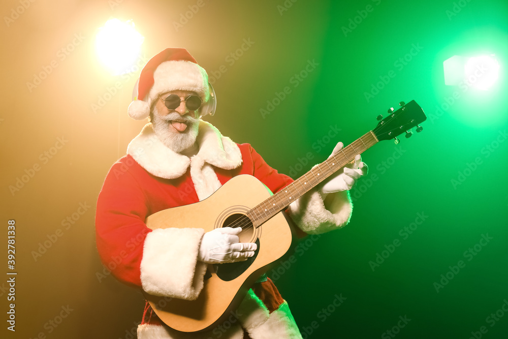 Cool Santa Claus with guitar on color background