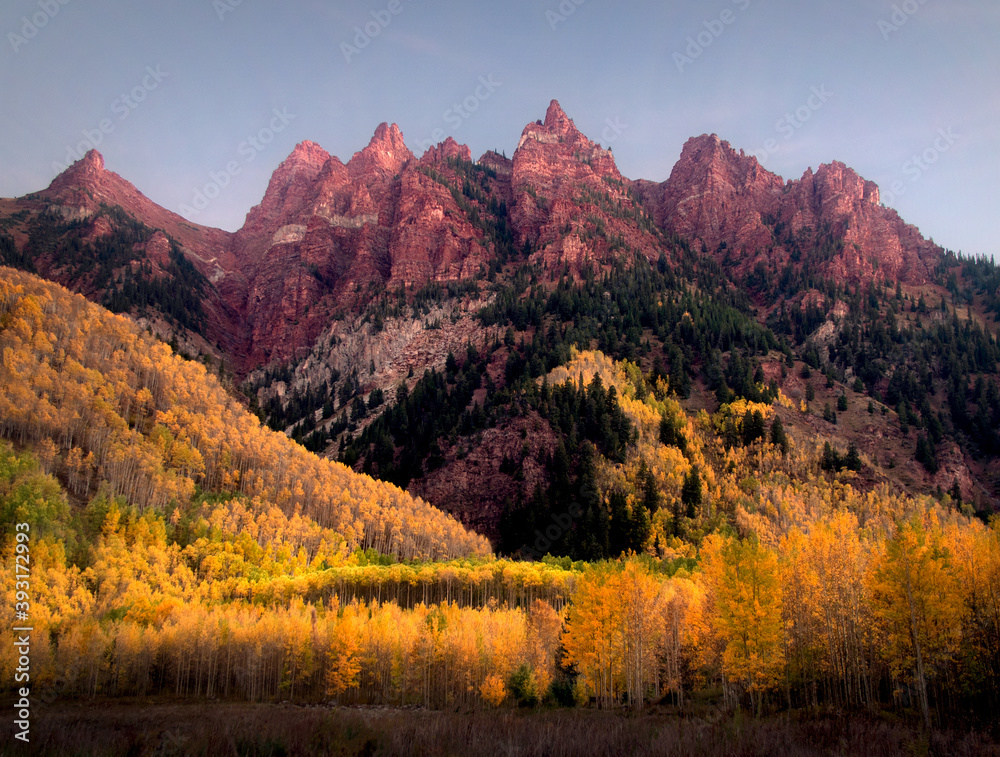 An autumn sunrise across Sievers Mountain near Maroon Bells in Aspen, Colorado. 