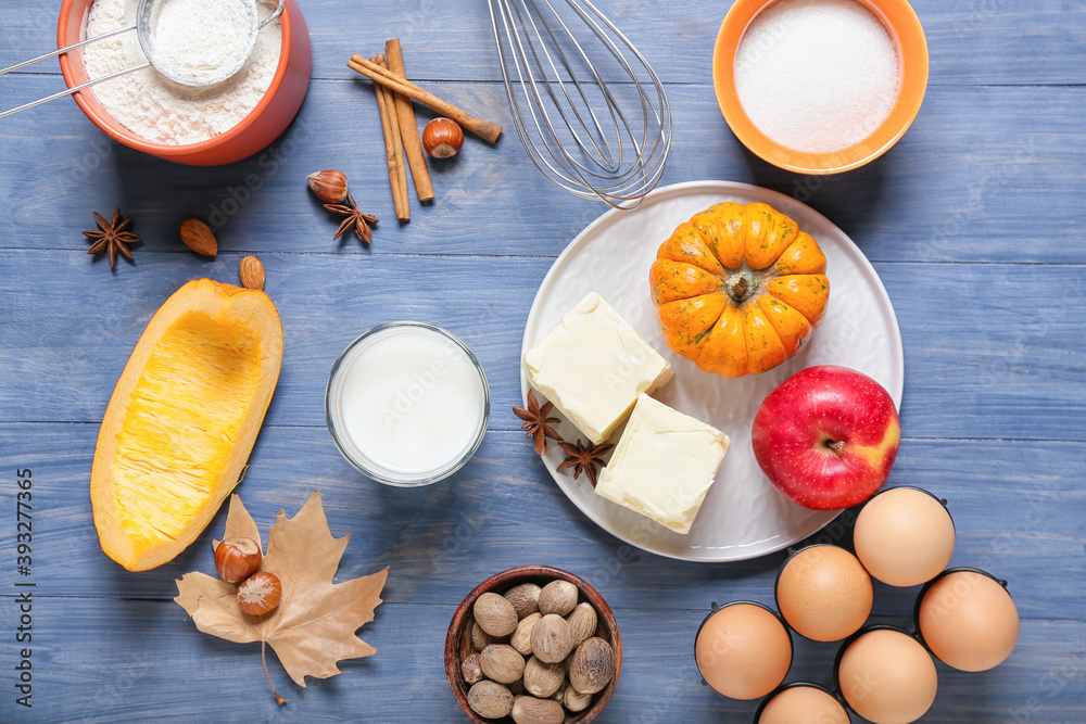 Ingredients for preparing pumpkin pie on color wooden background