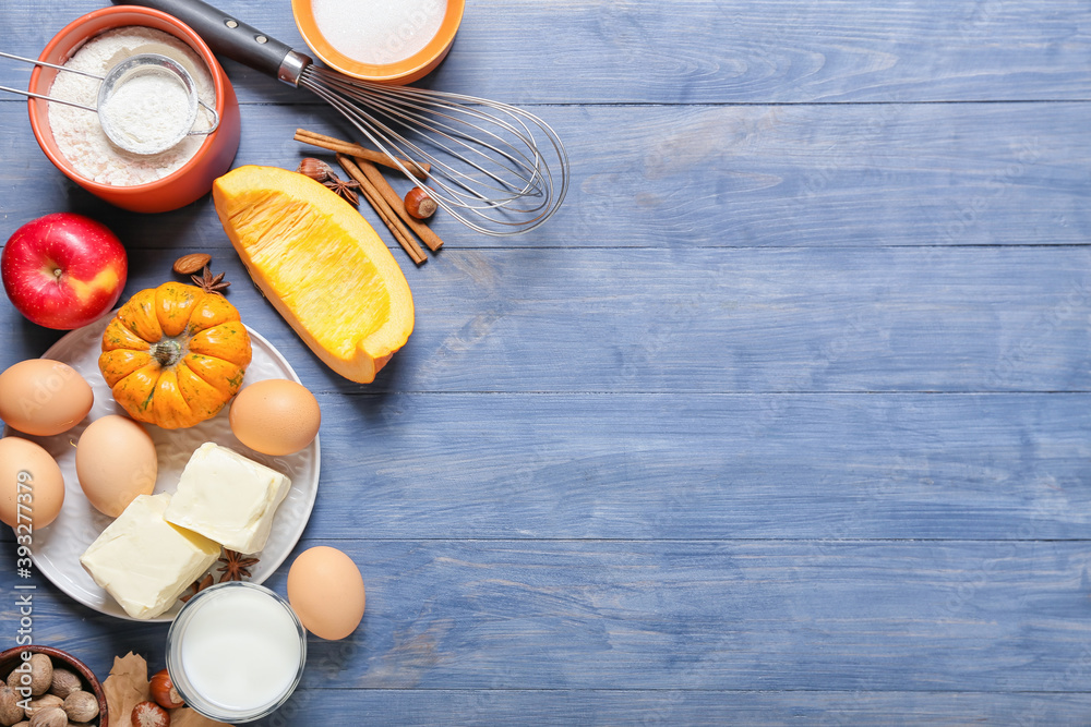 Ingredients for preparing pumpkin pie on color wooden background