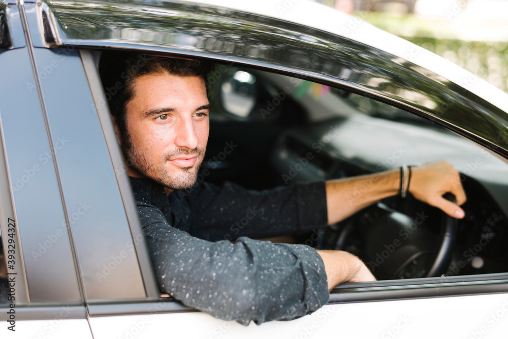 Handsome male driver sitting in a car