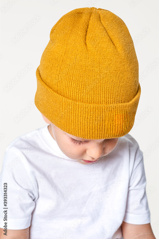 Boy wearing yellow beanie in studio