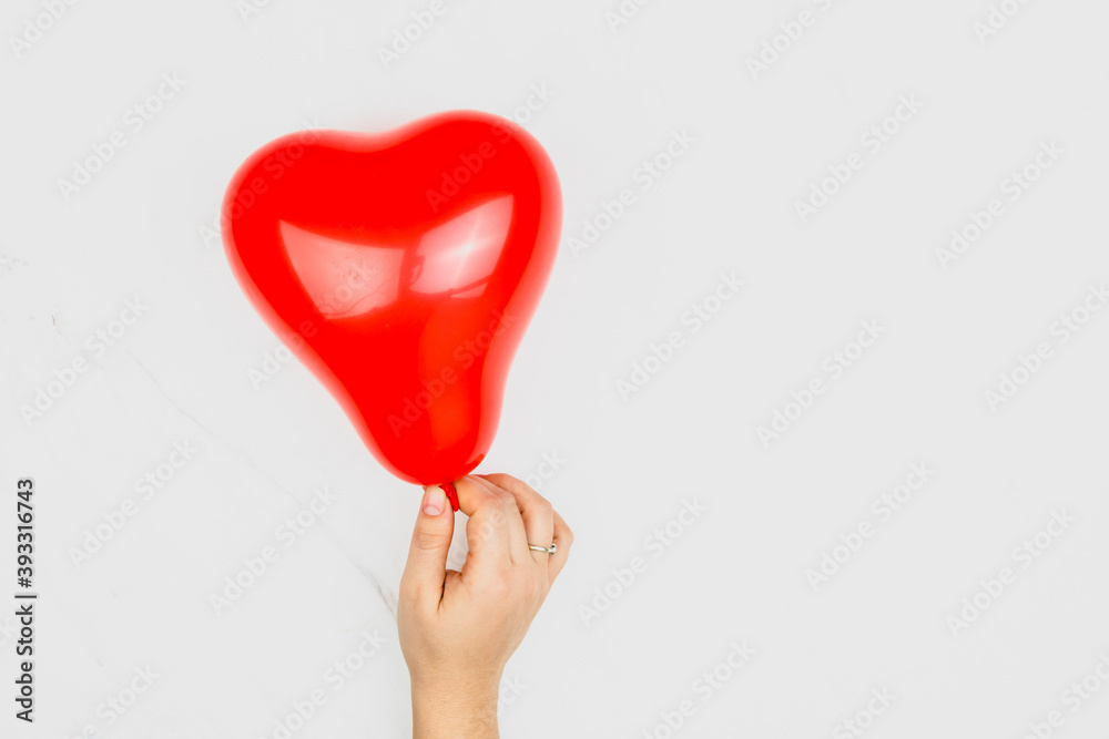 Red blown up heart shaped balloon