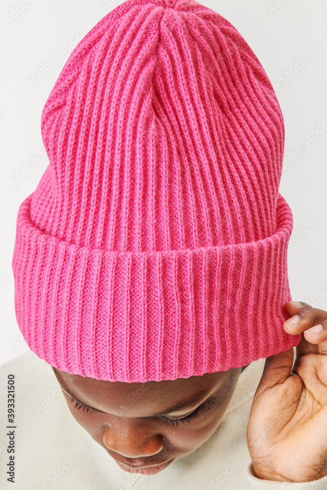 Boy wearing pink beanie in studio