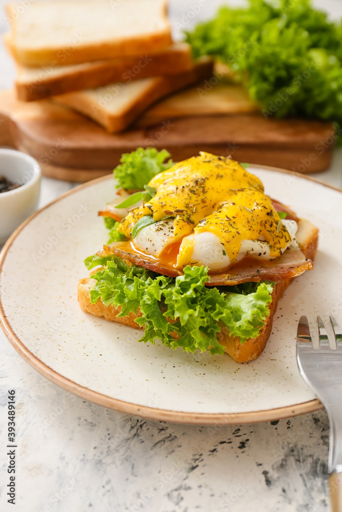 Plate with tasty egg Benedict on table