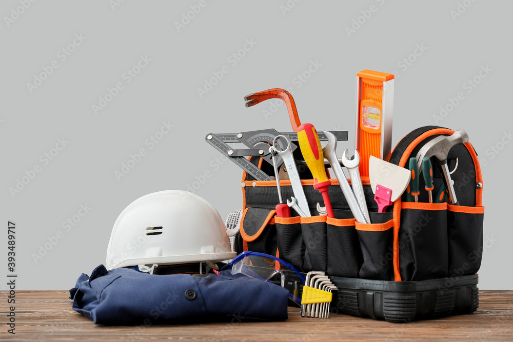 Set of construction tools on table against grey background