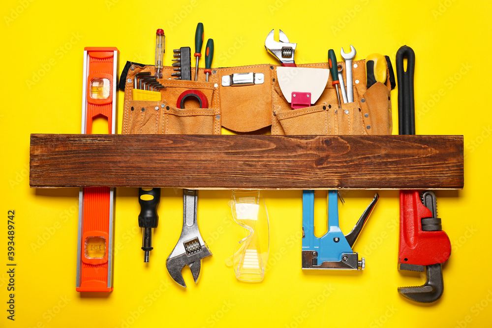 Set of construction tools on color background