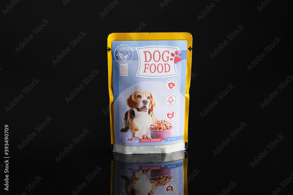 Tasty pet food on dark background