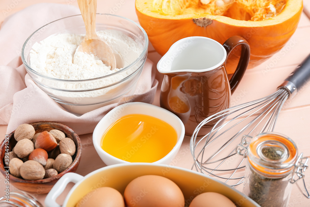 Ingredients for preparing pumpkin pie on color wooden background