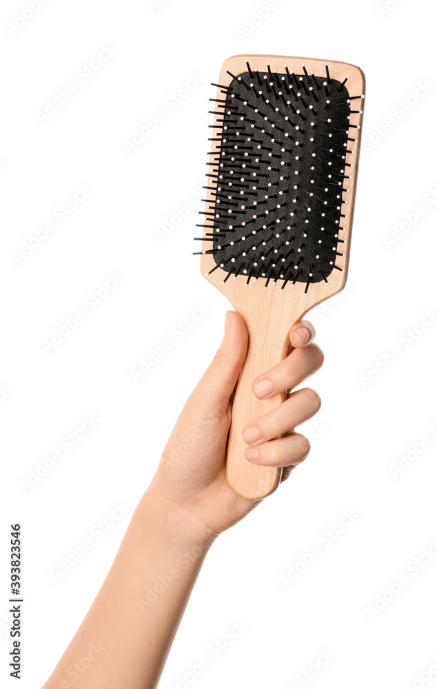 Woman hand and paddle brush on white background