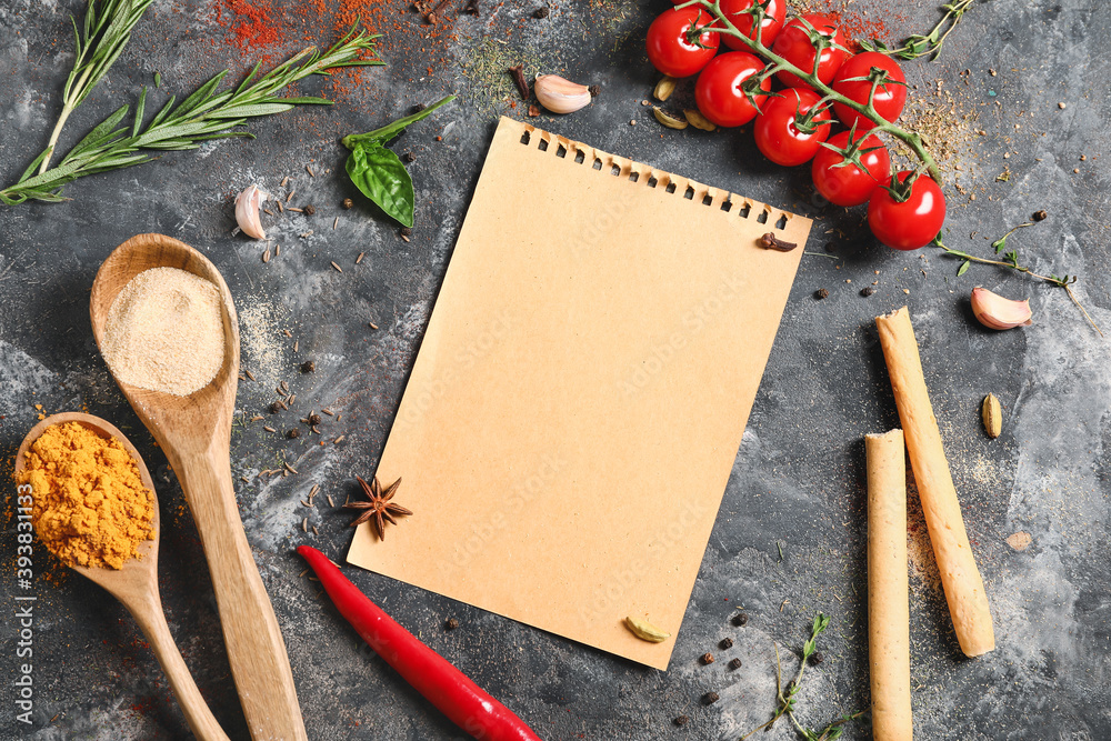 Blank beige paper, spices and cherry tomatoes on grey table