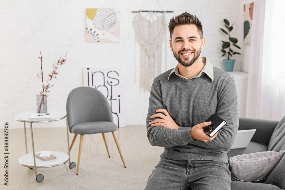 Portrait of young male psychologist in office