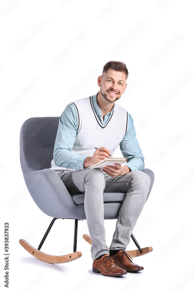 Male psychologist sitting in armchair on white background