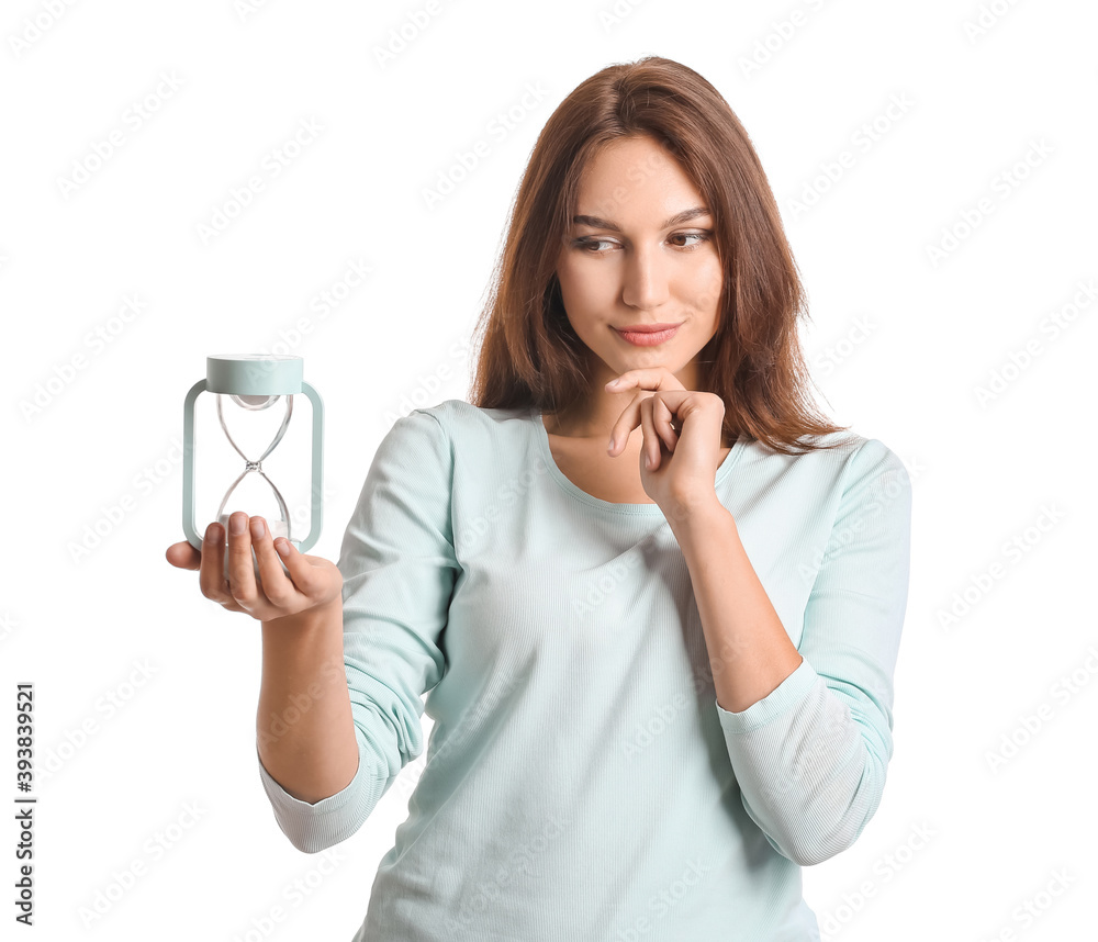 Young woman with hourglass on white background