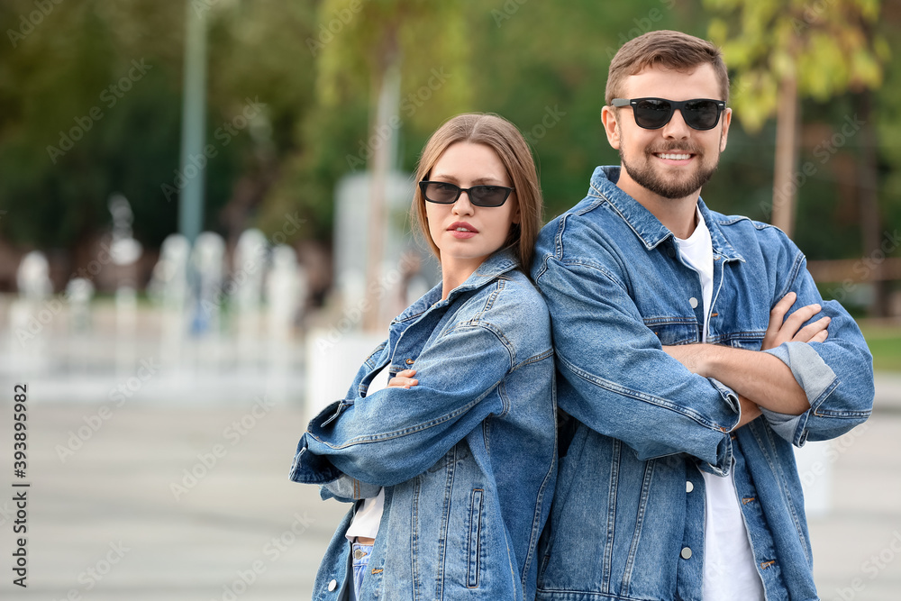 Young couple with stylish sunglasses outdoors