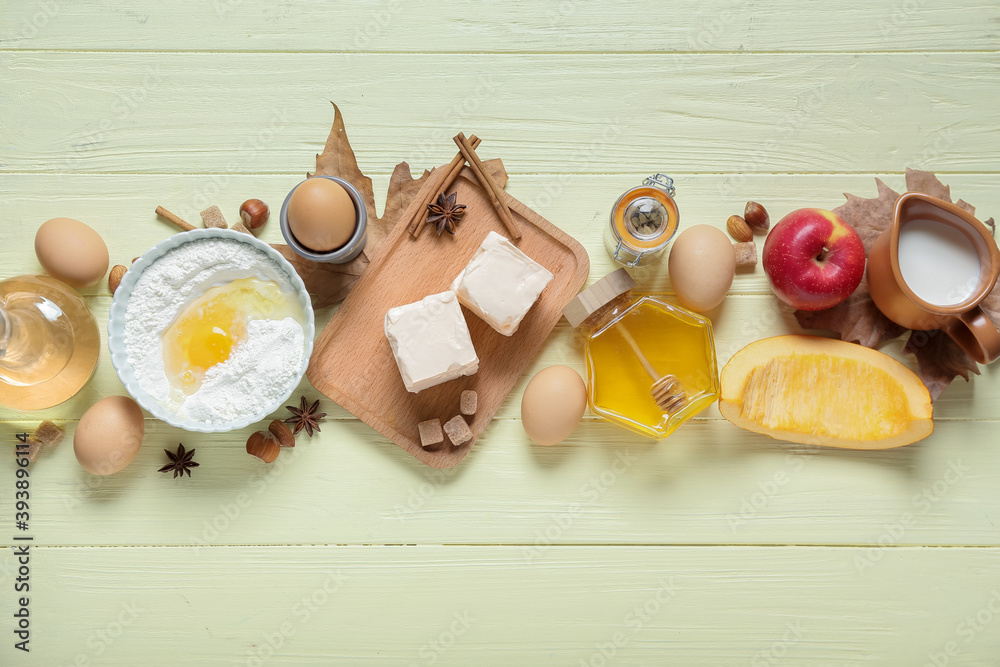 Ingredients for preparing pumpkin pie on color wooden background