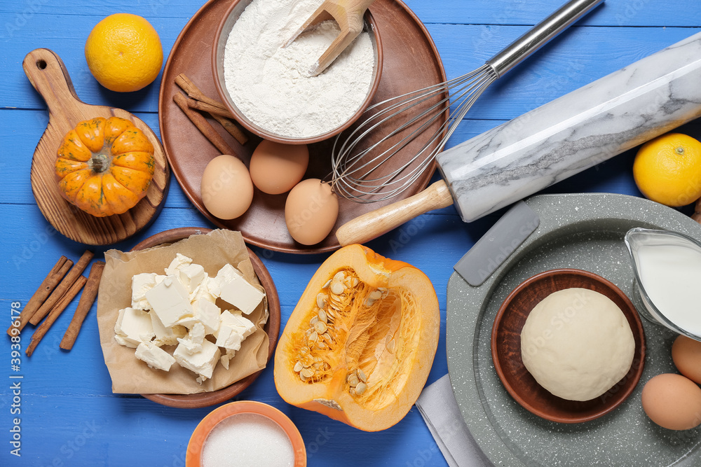 Ingredients for preparing pumpkin pie on color wooden background