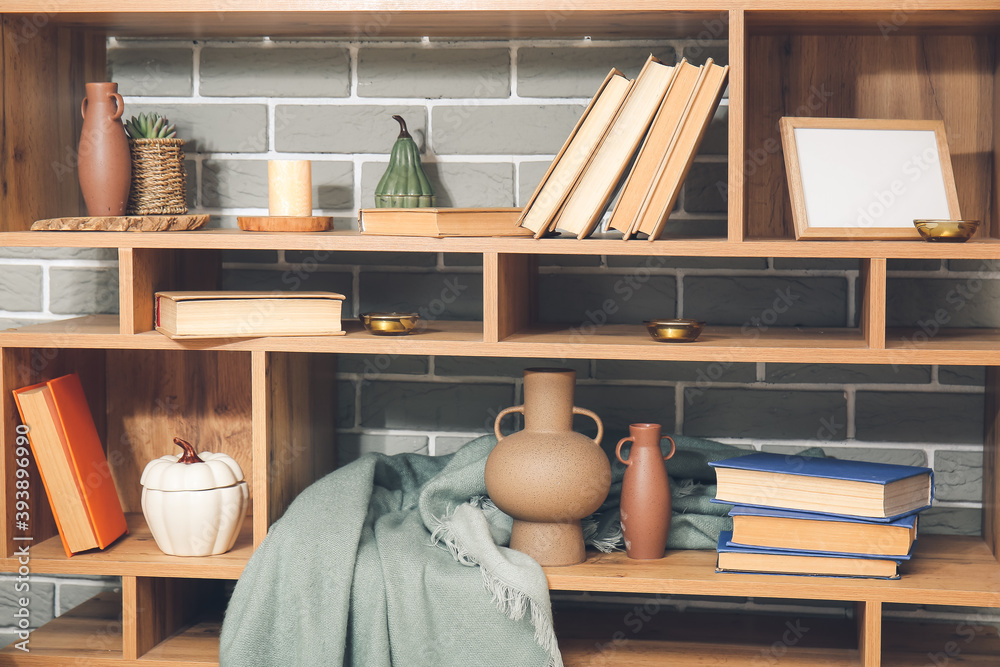 Shelf with books and decor in room